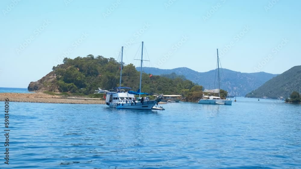 Moored sailboats by green mountains gulf. A view of moored fishing boats by the tropical beach in summer. Generative AI Moored sailboats by green mountains gulf. A view of moored fishing boats by the tropical beach in summer. Generative AI