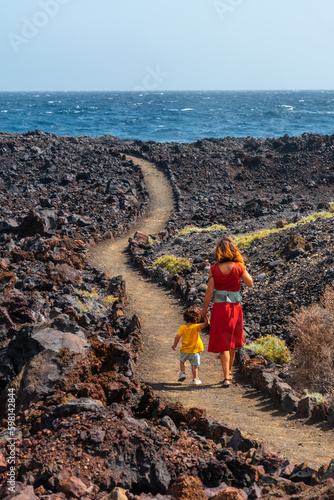 Walking on the volcanic path in the town of Tamaduste on the coast of the island of El Hierro, Canary Islands, Spain photo