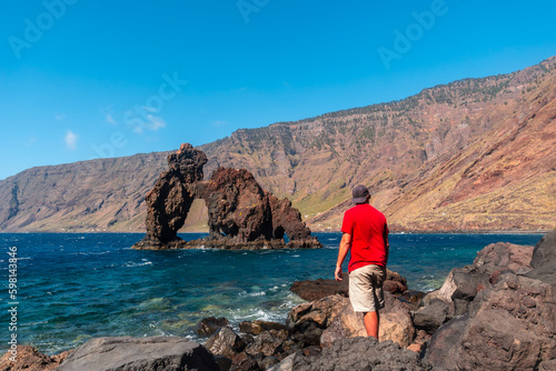 A tourist man at the Roque de la Bonanza on the island of El Hierro, Canary Islands, Spain