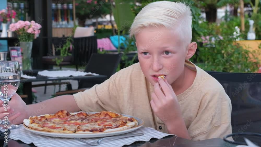 Happy little boy eating kid's pizza in the restaurant. Menu for children, animal shaped italian pizza for youngsters. High quality 4k footage Generative AI Happy little boy eating kid's pizza in the restaurant. Menu for children, animal shaped italian pizza for youngsters. High quality 4k footage Generative AI