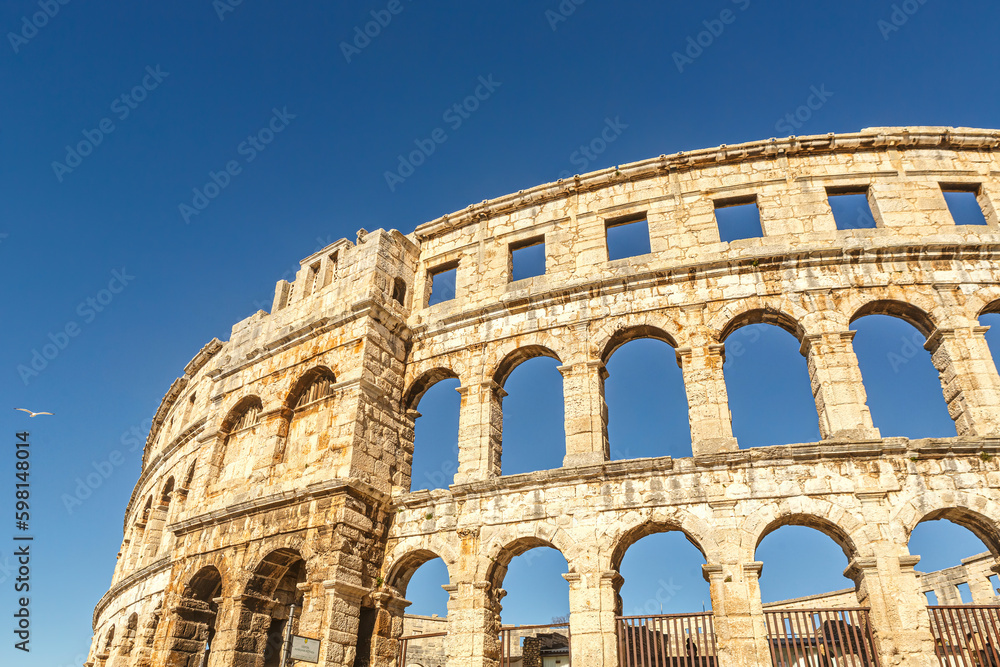 View at the amphitheatre in Pula, Istria, Croatia, in early spring during a sunny day against clear blue sky