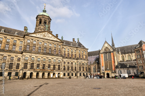 Amsterdam, Netherlands - March 28, 2023: The Royal Palace and the New Church surrounding Dam Square in Amsterdam 