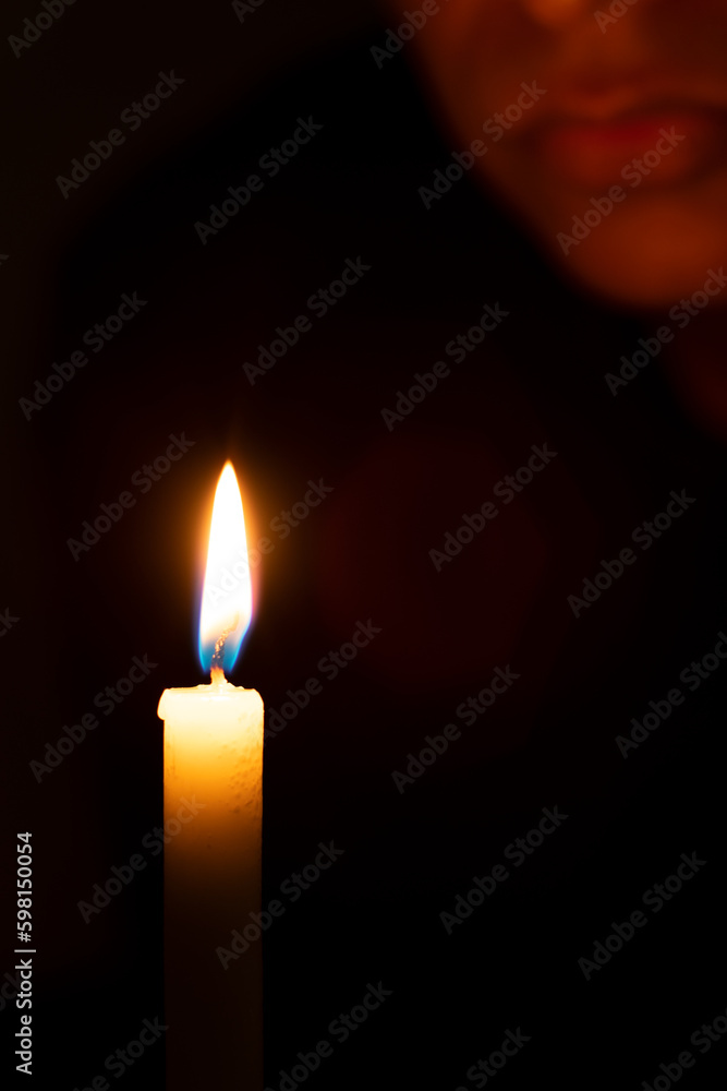 person lit by a candle person lit by a candle