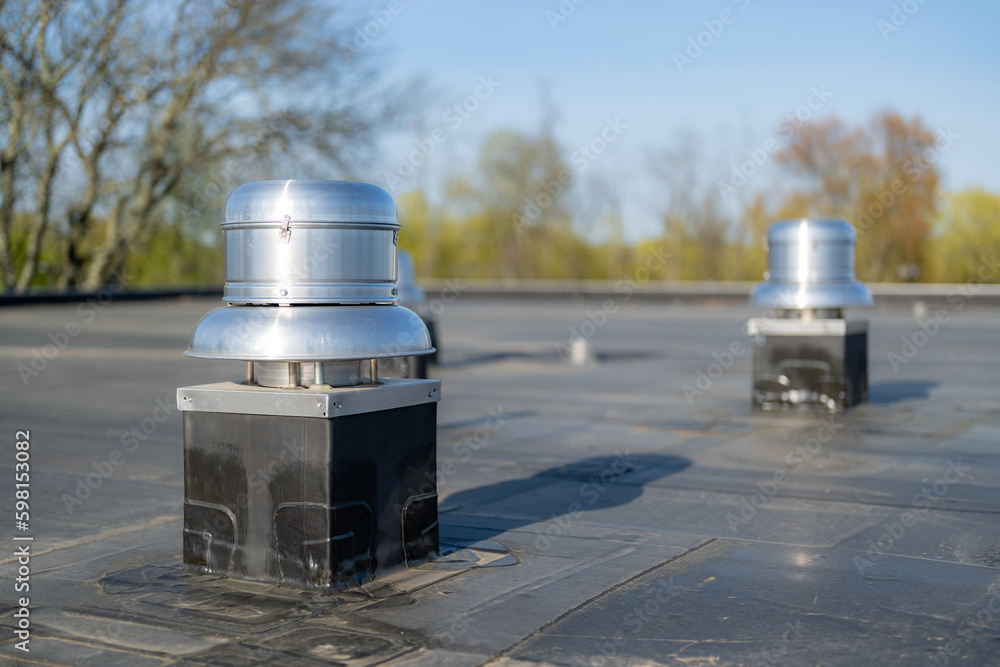 Photo of a roof exhaust ventilation fan on a new EPDM on a large commercial building Photo of a roof exhaust ventilation fan on a new EPDM on a large commercial building