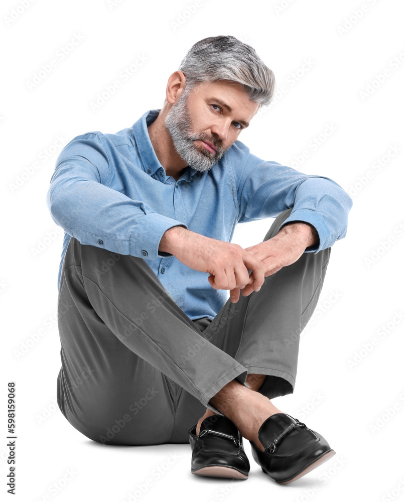 Mature businessman in stylish clothes sitting on white background Mature businessman in stylish clothes sitting on white background