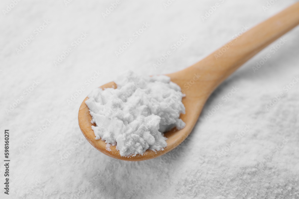 Heap of natural starch and wooden spoon, closeup Heap of natural starch and wooden spoon, closeup