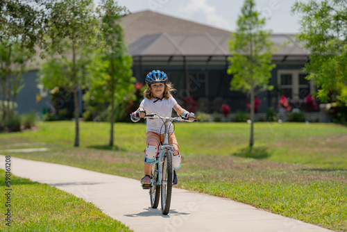 Wallpaper Mural Little kid boy riding a bike in summer park. Children learning to drive a bicycle on a driveway outside. Kid riding bikes in the city wearing helmets as protective gear. Child on bicycle outdoor. Torontodigital.ca