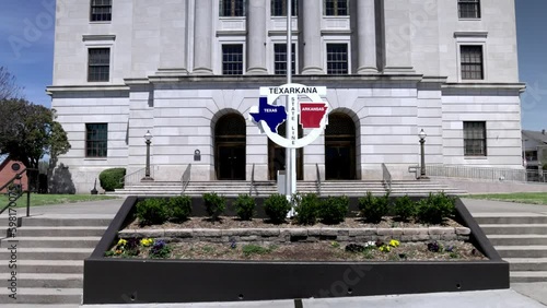 Texarkana state line sign between Texas and Arkansas with gimbal video walking forward close up. photo