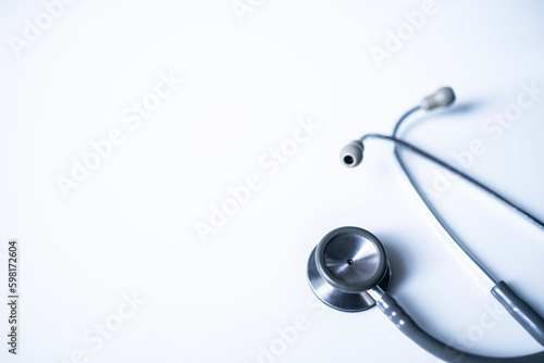 Panorama of medical stethoscope on white blur background with copy space inside hospital.Close up photo of tool for doctor or veterinary use.Beautiful clipboard for text.Clean ear piece and tube. photo