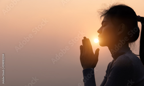 Fotografija woman Praying hands with faith in religion and belief in God On the morning sunrise background