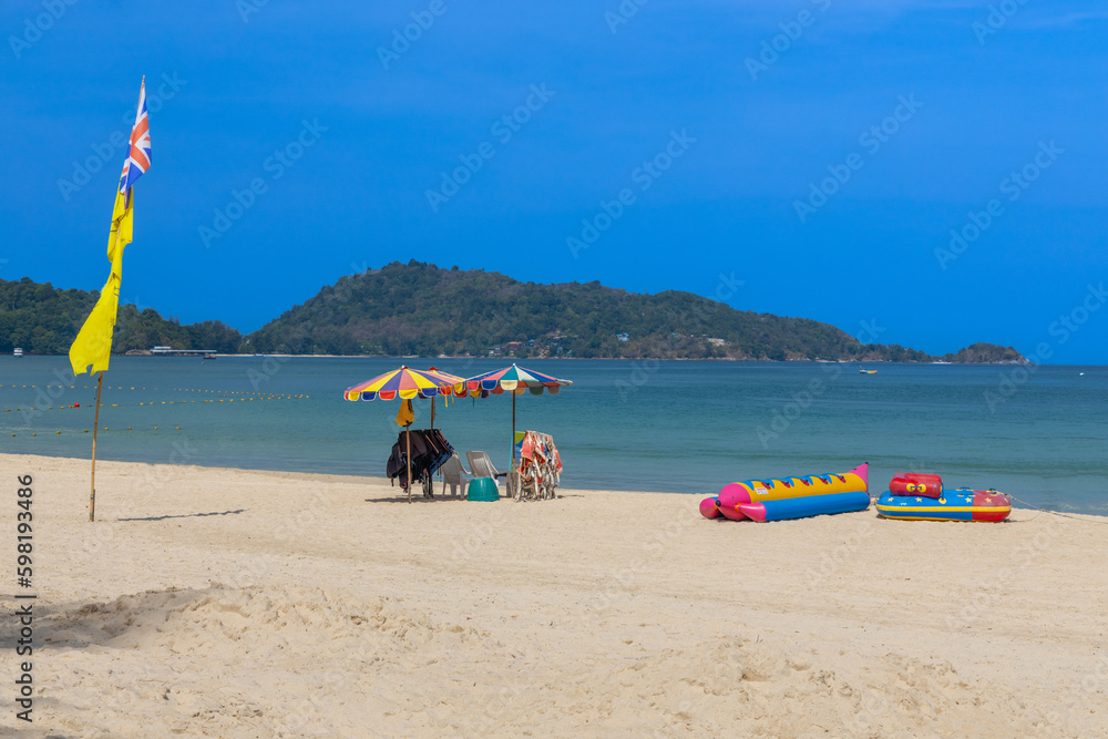 Fototapeta premium Patong Beach Phuket Thailand nice white sandy beach clear blue and turquoise waters and lovely blue skies with Palms tree