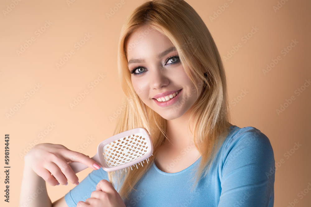 Studio portrait of attractive pretty haired girl combing hair. Hair care, hairs salon. Beautiful woman with healthy skin straight hair isolated on studio background. Hairs day. Beautiful smooth hair. Studio portrait of attractive pretty haired girl combing hair. Hair care, hairs salon. Beautiful woman with healthy skin straight hair isolated on studio background. Hairs day. Beautiful smooth hair.