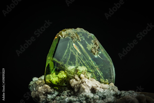 green titanite (also called sphene). macro detail texture background. close-up raw rough unpolished semi-precious gemstone
 photo