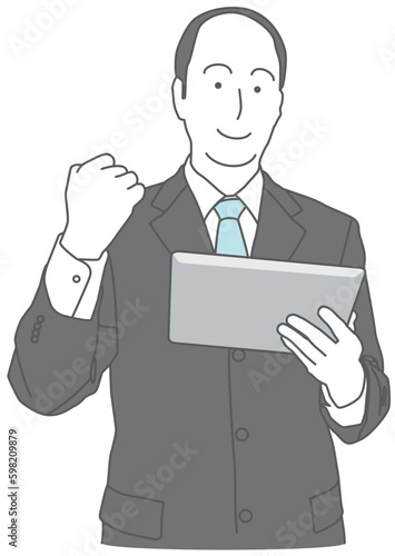 タブレット端末を持って握り拳をするスーツを着た男性