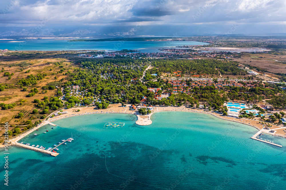 Zaton, Croatia - Aerial view of Zaton tourist waterfront with turquoise sea water, Nin village and Velebit mountains at background on a sunny summer day in Dalmatia region of Croatia