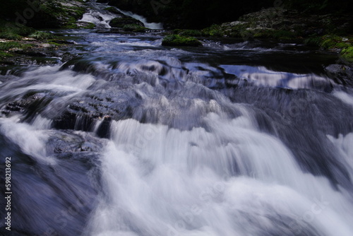 A landscape photo of a mountain stream in autumn.