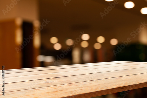wooden table and bokeh cafe background. product display template
