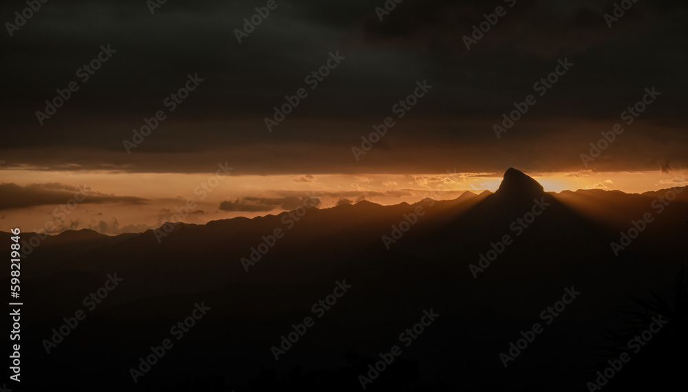 Majestic sunset illuminating mountain range and rock formation Majestic sunset illuminating mountain range and rock formation