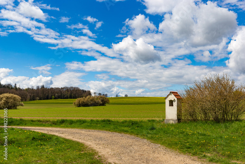 Small chapel in springtime field. photo