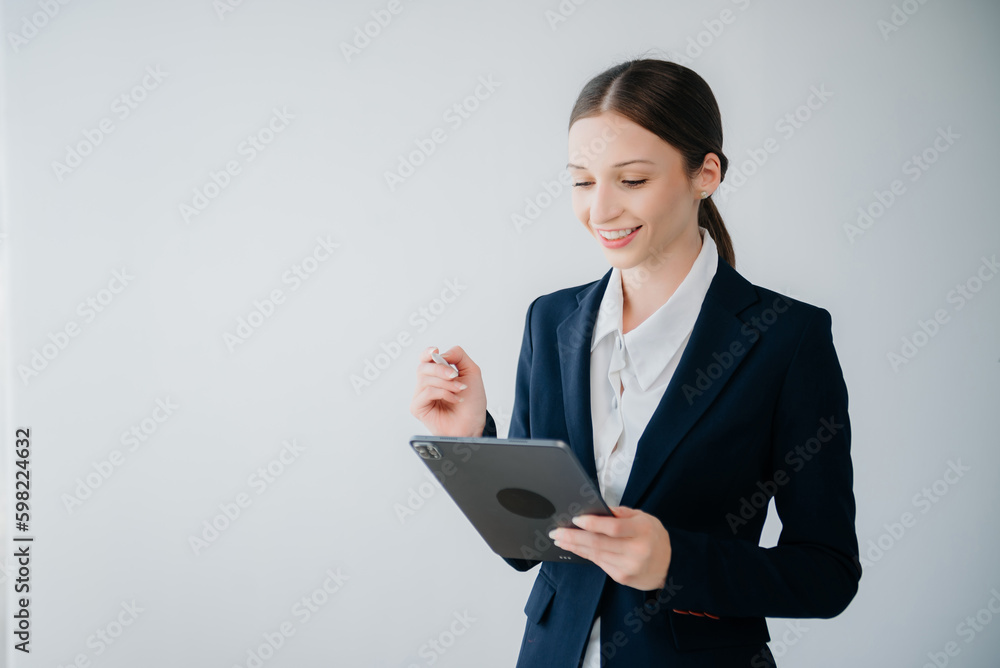 Smiling caucasian young businesswoman bank employee worker manager boss ceo looking at camera, using tablet, laptop and notepad online isolated background.. Smiling caucasian young businesswoman bank employee worker manager boss ceo looking at camera, using tablet, laptop and notepad online isolated background..