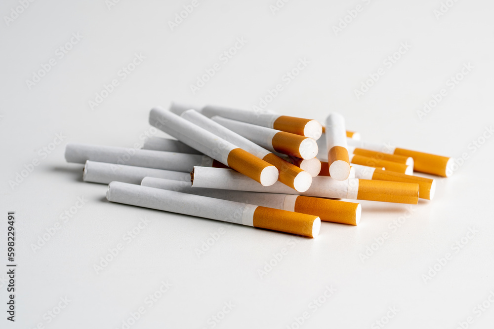 Many cigarettes on white background with copy space. The drug is harmful to the respiratory system. Many cigarettes on white background with copy space. The drug is harmful to the respiratory system.
