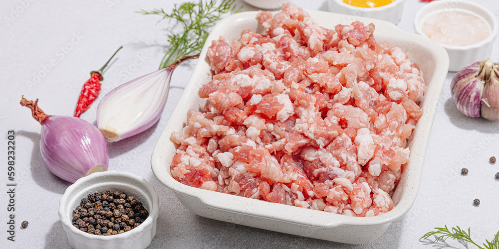 Raw minced meat, spices and herbs. Traditional ingredients for cooking cutlets or meatballs Raw minced meat, spices and herbs. Traditional ingredients for cooking cutlets or meatballs