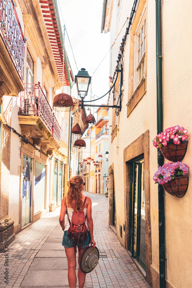 Rear view of woman walking in portuguese street- travel in Europa city- Portugal