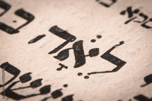 Obraz na płótnie Closeup of hebrew word in Torah page. English translation is name Leah. Unloved wife of the Biblical patriarch Jacob. Selective focus. w salonie