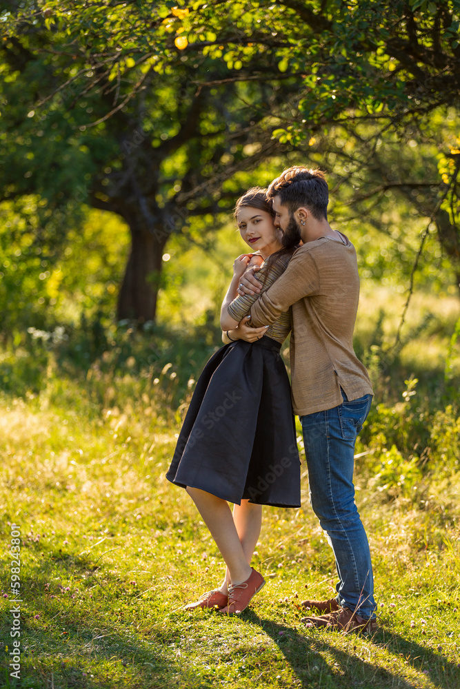 Fototapeta premium man hugging his girlfriend in nature