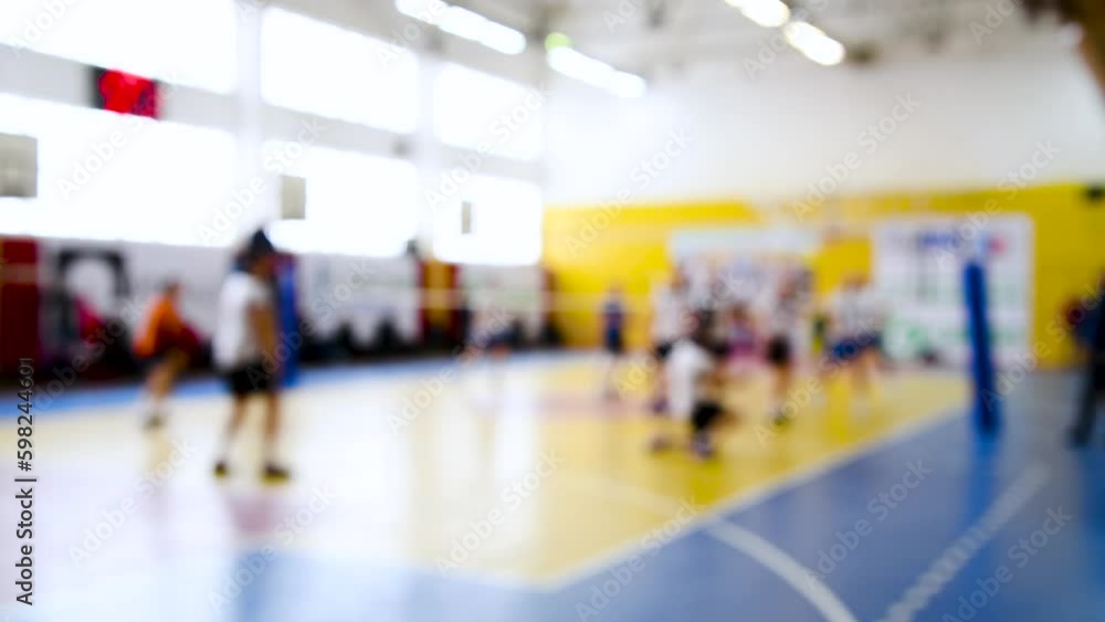 The men's team plays indoor volleyball. Blurry. The men's team plays indoor volleyball. Blurry.