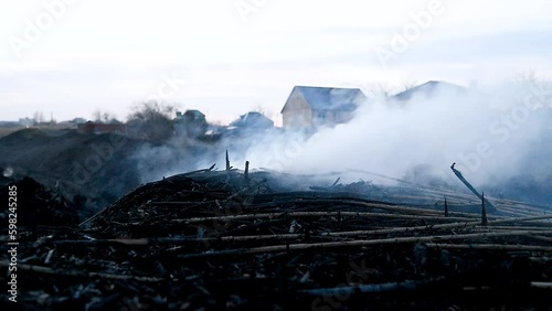 Fire in a field near houses