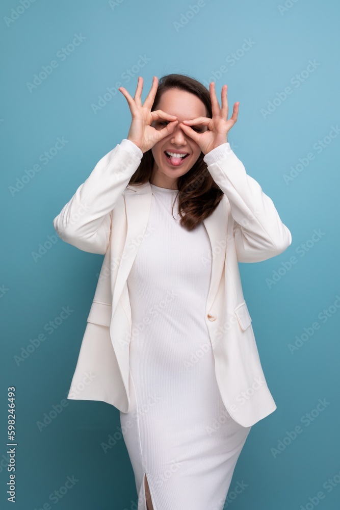 European pretty brunette young woman in a dress and jacket with a grimace European pretty brunette young woman in a dress and jacket with a grimace