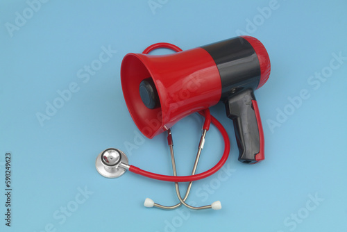 Stethoscope and red megaphone. Medical information and call for medical help concept.