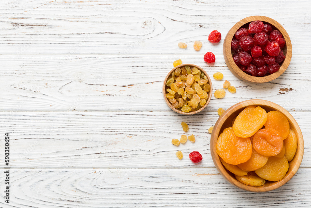 Bowl with different dried fruits on table background, top view. Healthy lifestyle with copy space Bowl with different dried fruits on table background, top view. Healthy lifestyle with copy space