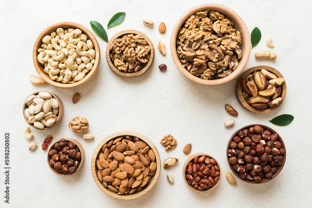 mixed nuts in wooden bowl. Mix of various nuts on colored background. pistachios, cashews, walnuts, hazelnuts, peanuts and brazil nuts mixed nuts in wooden bowl. Mix of various nuts on colored background. pistachios, cashews, walnuts, hazelnuts, peanuts and brazil nuts