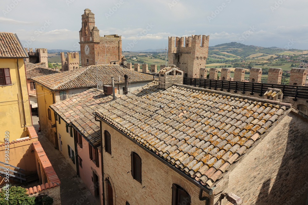 View over the roofs and walls of Gradara hamlet and the hilly landscape of the Marche region, Italy