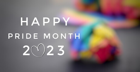 Happy pride month 2023 with blurred rainbow paper ball background, concept for LGBT community celebrations in pride month, June, around the world.