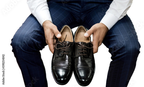 Elegant man holding stylish men's shoes