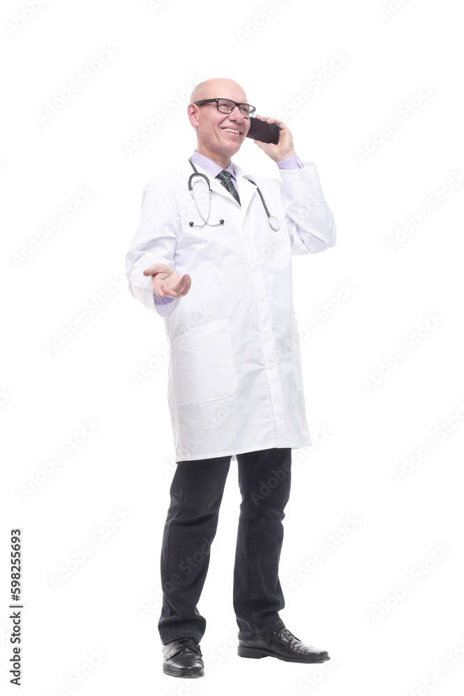 in full growth. smiling doctor with a smartphone.