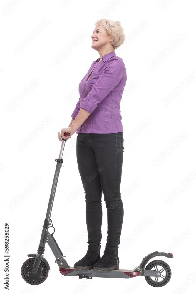 smiling mature woman with an electric scooter . smiling mature woman with an electric scooter .