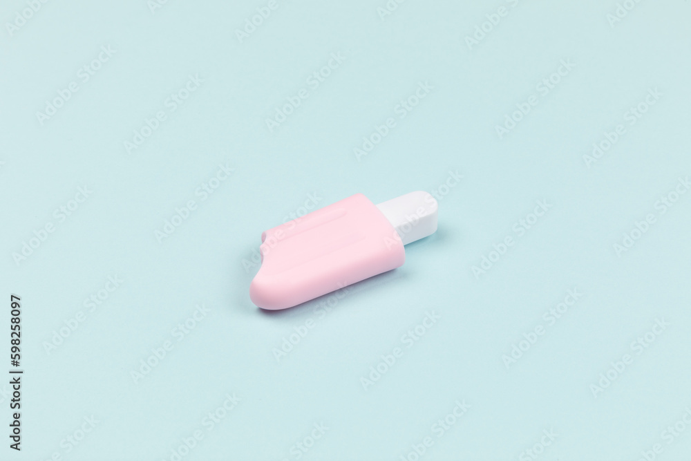 closeup of a pink popsicle on cyan surface icecream closeup of a pink popsicle on cyan surface icecream