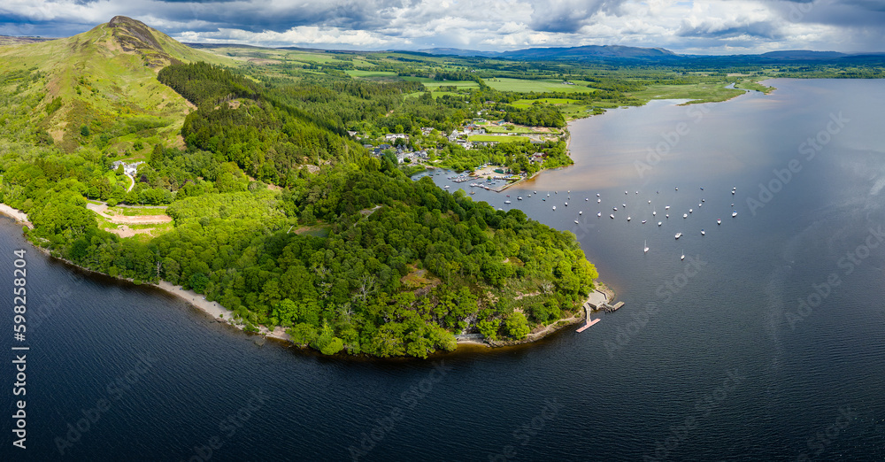 Panoramic aerial view of Conic Hill and Balmaha on the shores of Loch Lomond (Highlands, Scotland) Panoramic aerial view of Conic Hill and Balmaha on the shores of Loch Lomond (Highlands, Scotland)