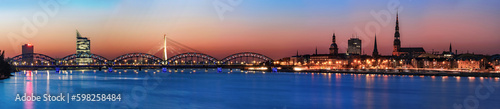 Panoramic night view across river of Riga  Latvia. Copy space in sky and water.