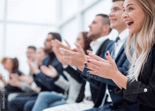 group of employees applauds during a business meeting