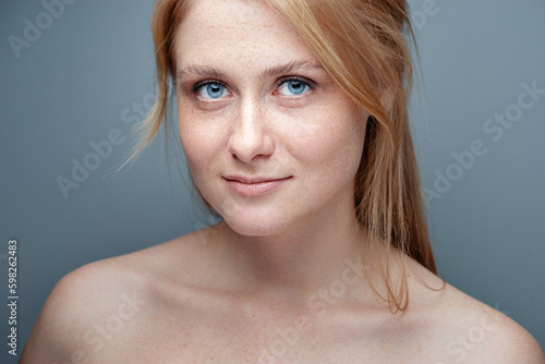 Fototapeta Naklejka Na Ścianę i Meble -  Natural beauty. Blonde woman with healthy skin.  No makeup. Grey background.