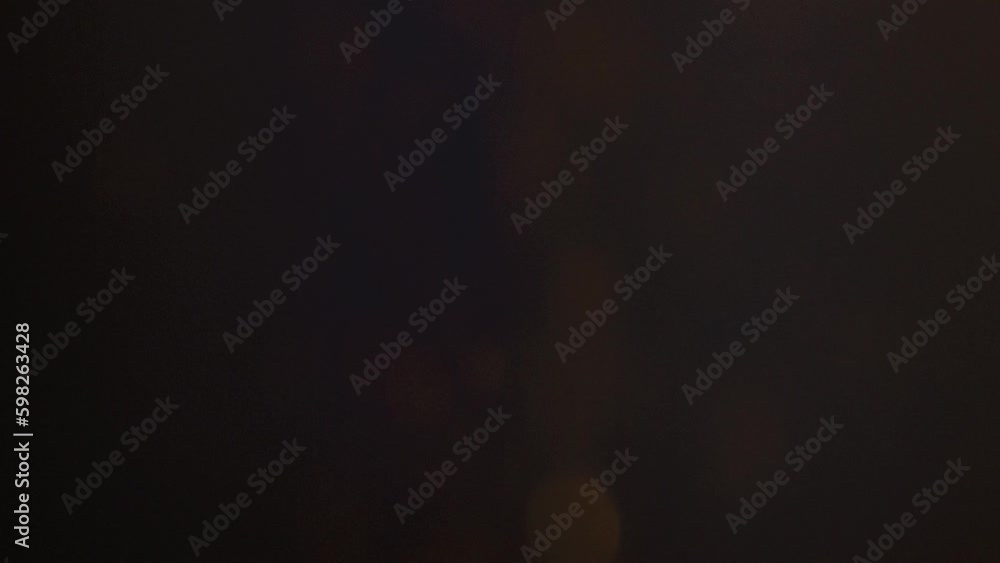 Golden ember sparks floating upward dark background. 100mm Macro Slow Motion 240fps. Golden ember sparks floating upward dark background. 100mm Macro Slow Motion 240fps.