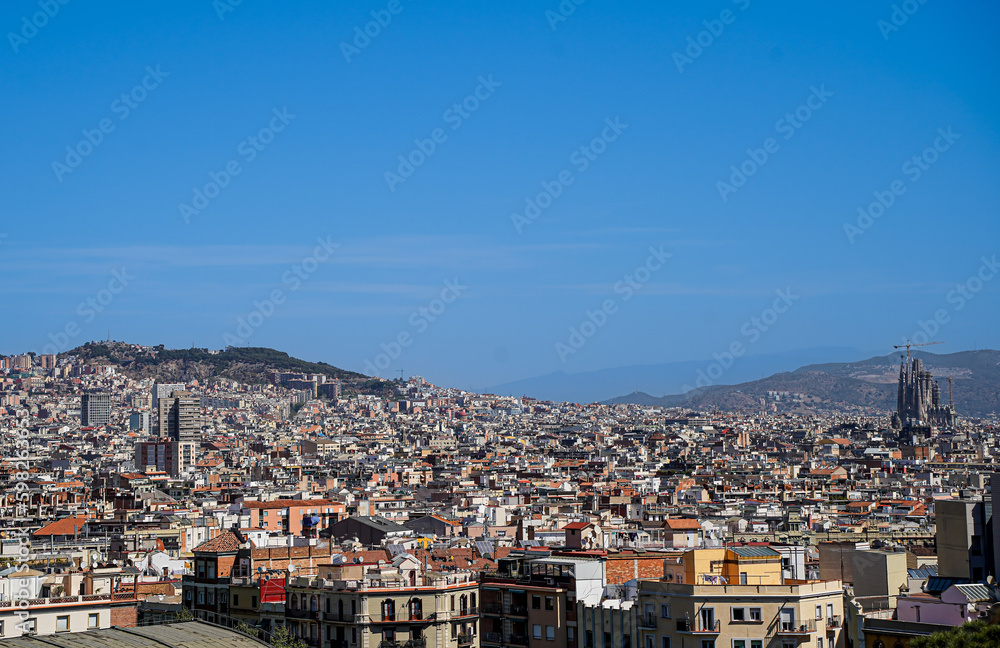 The wide panorama of the roofs of Barcelona with Sagrada Familia. 