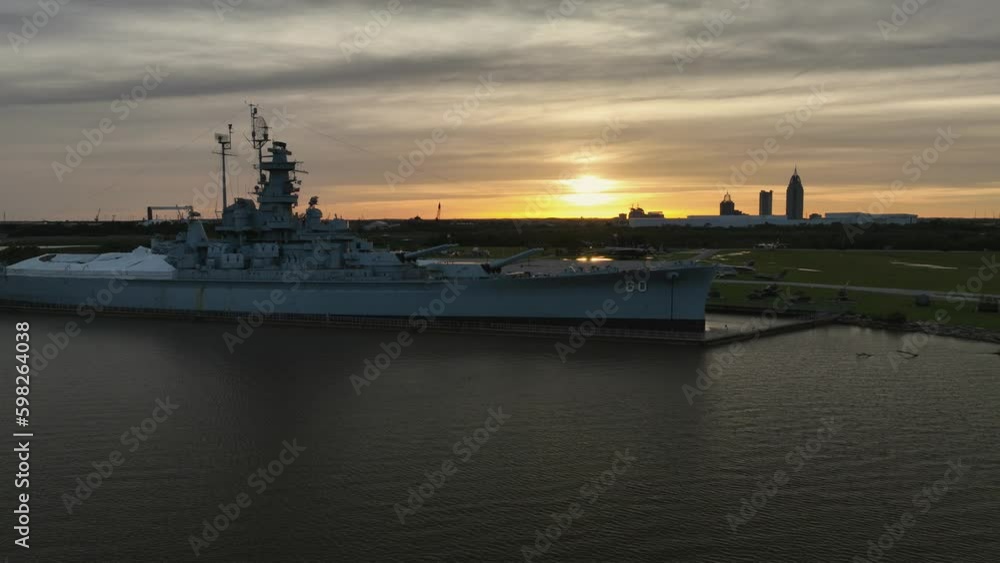 Aerial reverse reveal of the USS Alabama and the city of Mobile in the background Aerial reverse reveal of the USS Alabama and the city of Mobile in the background