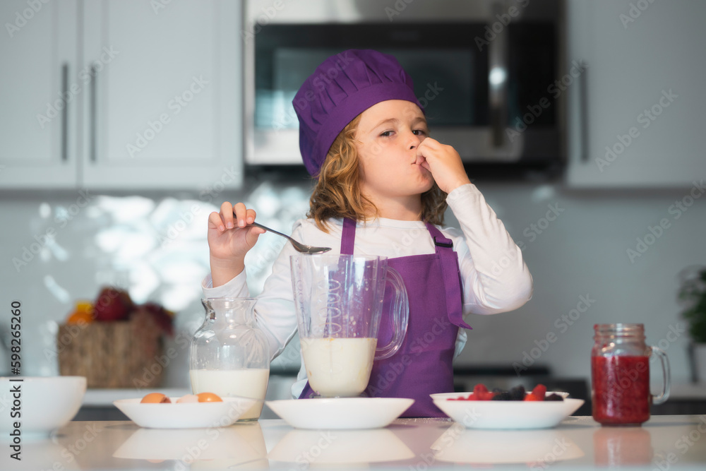 Chef child cooking healthy meal and dinner preparation. Chef child in apron and chef hat cooking at kitchen. Healthy food. Chef child cooking healthy meal and dinner preparation. Chef child in apron and chef hat cooking at kitchen. Healthy food.