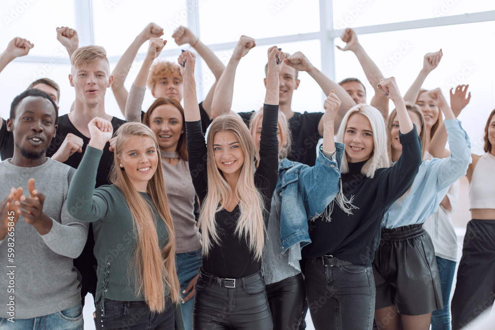 close up. group of smiling young people showing their success close up. group of smiling young people showing their success